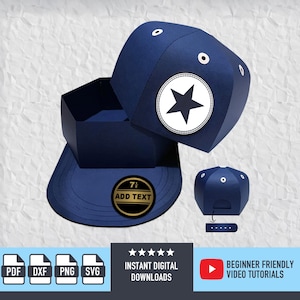 May include: A navy blue baseball cap-shaped box with a white star emblem. The box is open, revealing its interior. A smaller, detached cap shape is also present. The design includes the text "ADD TEXT" on a circular emblem.