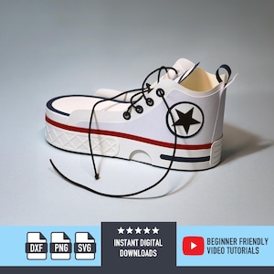 May include: A white papercraft sneaker with black laces, a red stripe, and a navy blue accent. A black star is on the side. The shoe is a papercraft design. The image also includes the text "INSTANT DIGITAL DOWNLOADS" and "BEGINNER FRIENDLY VIDEO TUTORIALS".