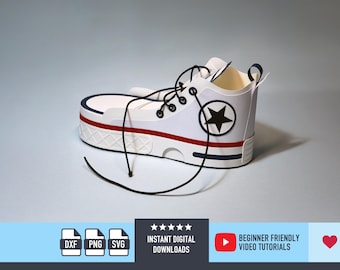 May include: A white papercraft trainer with black laces, a red stripe, and a navy blue accent. A black star is on the side. The shoe is a papercraft design. The image also includes the text "INSTANT DIGITAL DOWNLOADS" and "BEGINNER FRIENDLY VIDEO TUTORIALS".