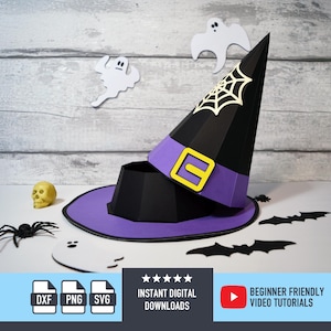 May include: A black and purple witch hat with a yellow buckle, a white spiderweb, and a skull. The image also includes paper cutouts of bats, ghosts, and a spider. The hat is a Halloween-themed craft.