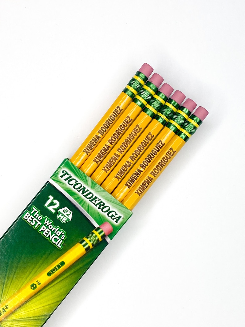 May include: A pack of 12 yellow pencils with green and black accents. The pencils are sharpened and have pink erasers. The pencils are labelled "Ticonderoga" and "The World's Best Pencil". Each pencil is personalised with the name "Ximena Rodriguez".