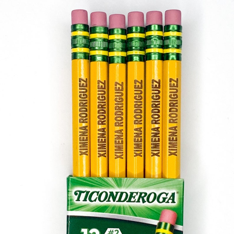 May include: A pack of six yellow pencils with green and pink accents. The pencils are personalised with the name "XIMENA RODRIGUEZ" printed on each pencil. The pencils are labelled "Ticonderoga #2".