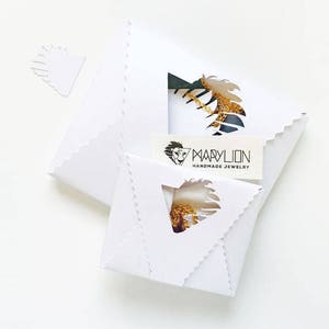 May include: White packaging with a gold chain necklace inside. The packaging has a logo that says "Marylion Handmade Jewelry".