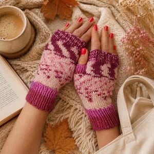 May include: A pair of fingerless gloves featuring a knit pattern in shades of magenta, dark purple, and cream. The gloves have ribbed cuffs at the wrists and knuckles, showcasing a repeating geometric design across the hand and thumb sections.
