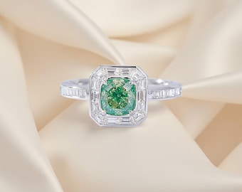 May include: A stunning ring featuring a square-cut, vibrant green gemstone at its center, surrounded by a halo of smaller, clear gemstones. The band is adorned with additional clear gemstones, creating a luxurious and elegant design.