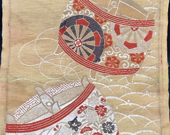 May include: A vintage Japanese textile with a gold background and a repeating pattern of white branches. Two large, stylized, red and white bowls with floral and geometric designs are featured on the textile.