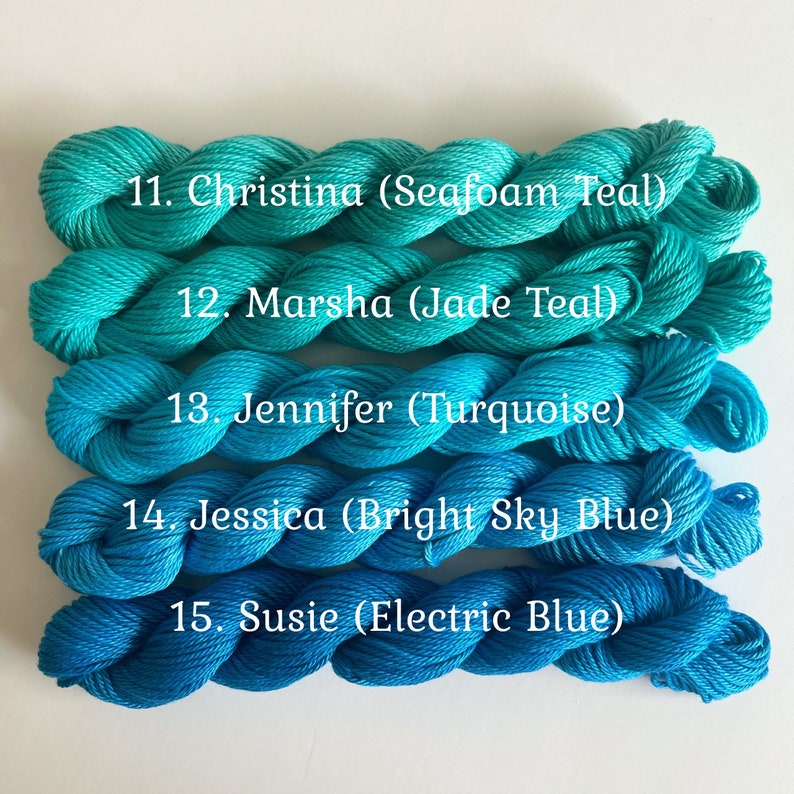 May include: Five skeins of yarn in shades of blue and teal. The yarn is labeled with numbers and names, including Seafoam Teal, Jade Teal, Turquoise, Bright Sky Blue, and Electric Blue.