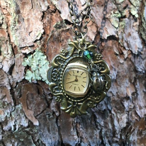 Beetle necklace with a clock 2025