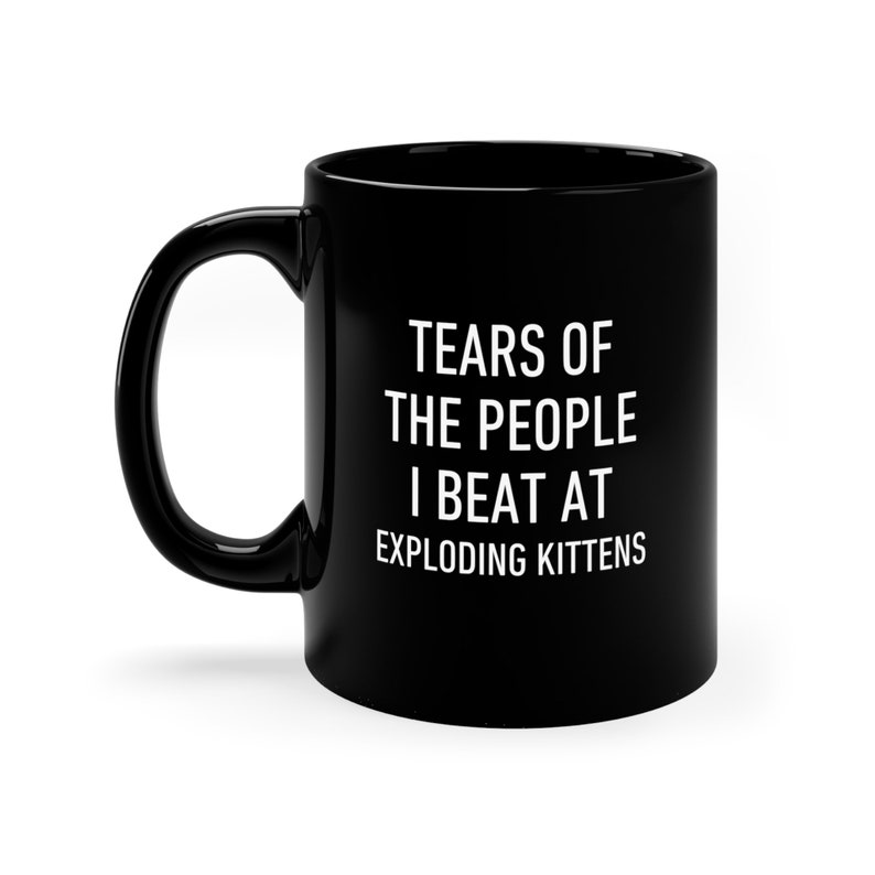 a black coffee mug that says tears of the people i beat at exploding kittens