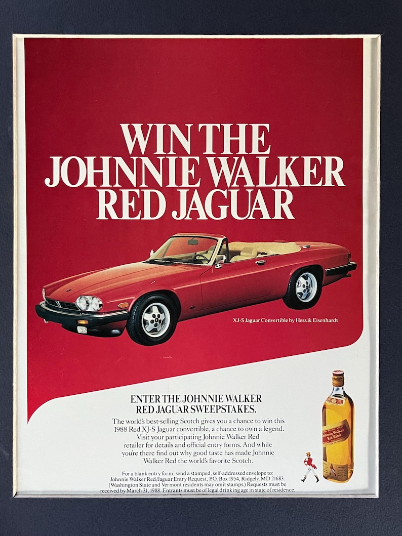 May include: An advertisement featuring a red 1988 XJ-S Jaguar convertible. The text reads "Win the Johnnie Walker Red Jaguar" and promotes a sweepstakes. A bottle of Johnnie Walker Red Scotch is also shown.