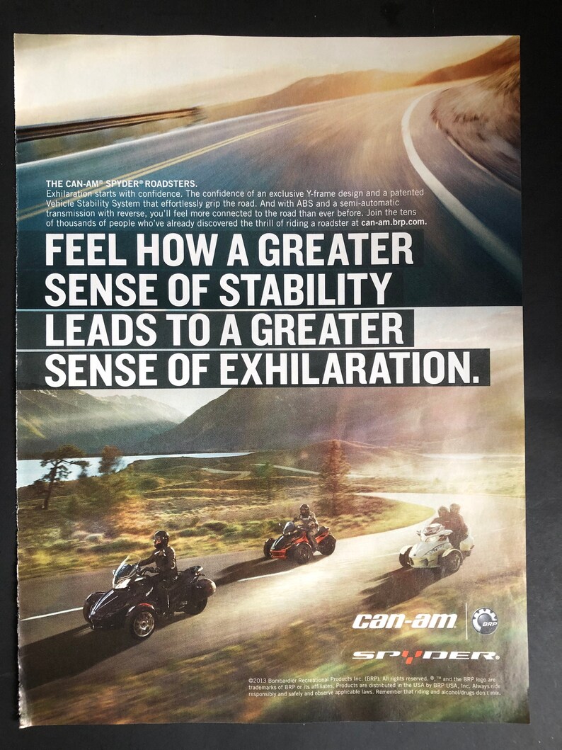 May include: A Can-Am Spyder roadster motorcycle is shown driving on a winding road. The motorcycle is red and black with a white windshield. The text "Feel how a greater sense of stability leads to a greater sense of exhilaration." is displayed on the image. The Can-Am Spyder logo is also shown.