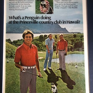 May include: A group of men wearing golf attire stand on a green golf course with a penguin wearing a bow tie and sunglasses. The text "What's a Penguin doing at the Princeville country club in Hawaii?" is at the top of the image. The text "munsingwear" is at the bottom of the image.