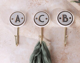 Hallie Monogram Hook | AnthroHome Anthropologie White and Bronze Monogram Wall Hooks (M & F & Ampersand) display picture 1