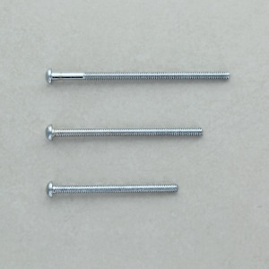 May include: Three silver screws of varying lengths, each with a round head.