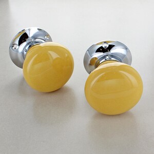 Pair Of Bright Yellow Ceramic Mortice Door Knobs With Brass Backplates 