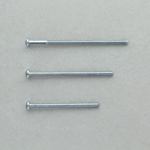 May include: Three silver machine screws of different lengths are displayed horizontally. The screws have a threaded shaft and a rounded head. The longest screw is about 10 cm long, the middle one is 7.6 cm, and the shortest is 5 cm. They are set against a neutral background.