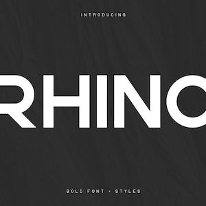 May include: A bold, white font called "Rhino" is displayed on a black background. The text "Introducing" appears above the font name, and "Bold Font - Styles" appears below.
