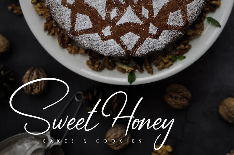 May include: A close-up of a round cake with a decorative design on top, dusted with powdered sugar. The cake is surrounded by walnuts and is on a white plate. The text "Sweet Honey Cakes & Cookies" is written in white cursive on a black background.