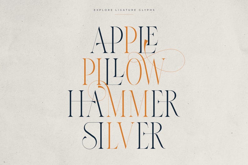 May include: A graphic design featuring the words "APPLE, PILLOW, HAMMER, SILVER" in a serif font. The text is in a combination of navy blue and orange, with decorative ligatures. The words are centered on a cream-colored background.