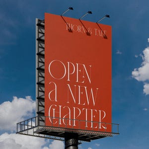 May include: A large billboard against a blue sky with white clouds. The billboard is a vibrant orange-red color and features the text "THORN & TALE" at the top and "OPEN a NEW CHAPTER" in elegant white lettering. The structure has a metal frame.