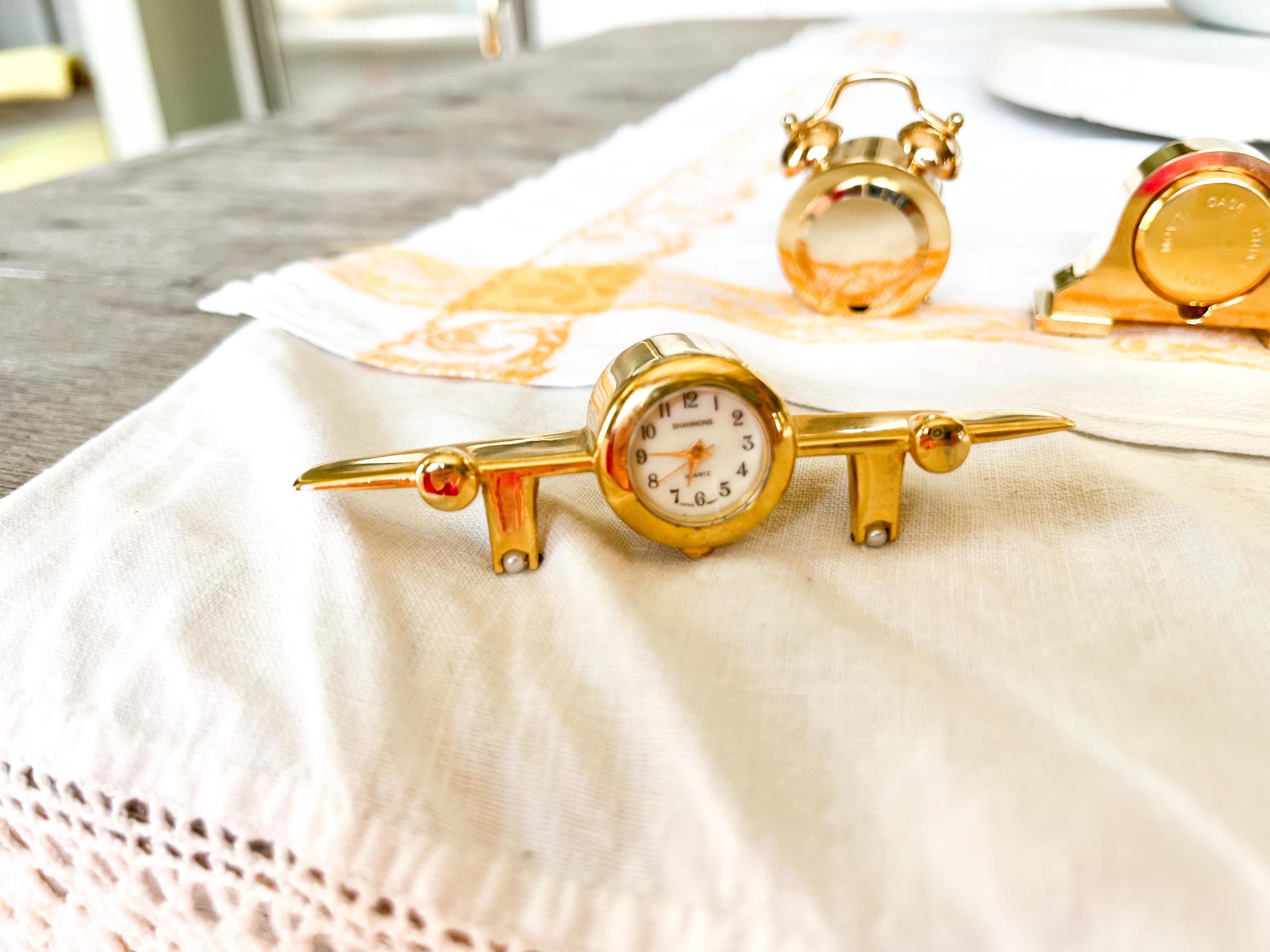 One Miniature Brass Clock, Bulova B-0407 Kingsley, Bulova B-0501