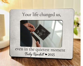 May include: A rectangular photo frame with a distressed white finish. The frame holds a sonogram image. Text on the frame reads "Your life changed us, even in the quietest moment Baby Randall 2025."