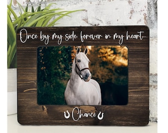 May include: A dark brown wooden picture frame featuring a photograph of a white horse. The frame is inscribed with the words "Once by my side, forever in my heart..." and "Chance" with horseshoe symbols.