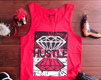 May include: Red tank top with a black and white graphic of a diamond and the word "Hustle".