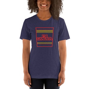 May include: A navy blue t-shirt with a red and yellow graphic of a ramen noodle cup with the text "I'M GANGSTA" printed on it.
