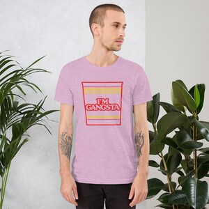 May include: A pink heather t-shirt with a red and yellow graphic of a ramen noodle cup that says "I'm Gangsta".