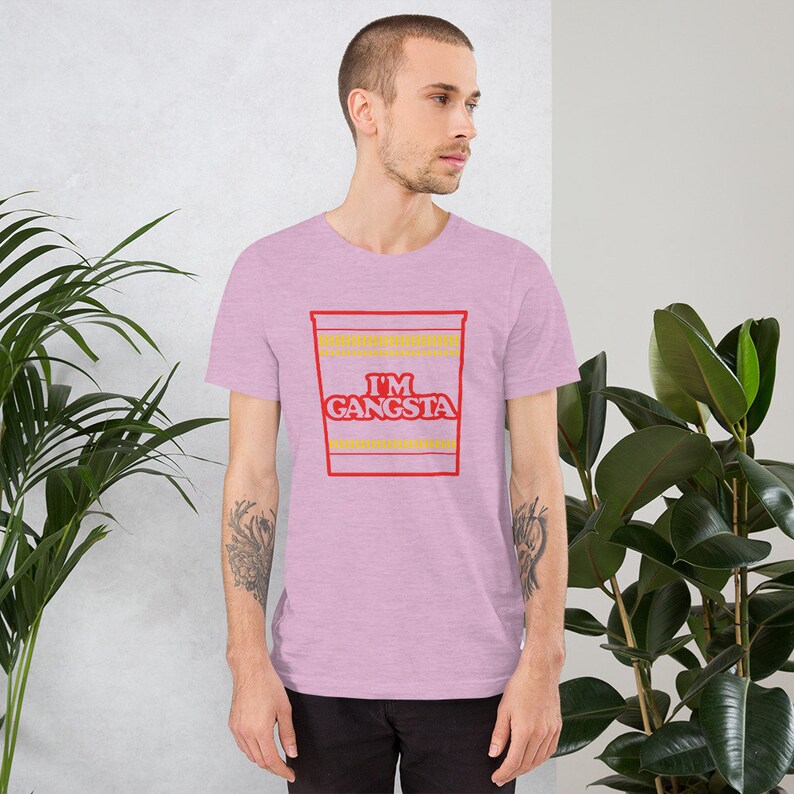 May include: A pink heather t-shirt with a red and yellow graphic of a ramen noodle cup that says "I'm Gangsta".