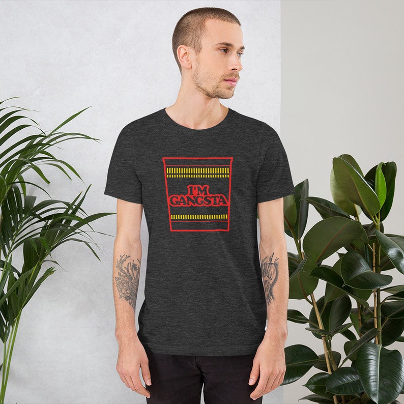 May include: A dark heather grey t-shirt with a red and yellow graphic of a ramen noodle cup with the text "I'M GANGSTA".