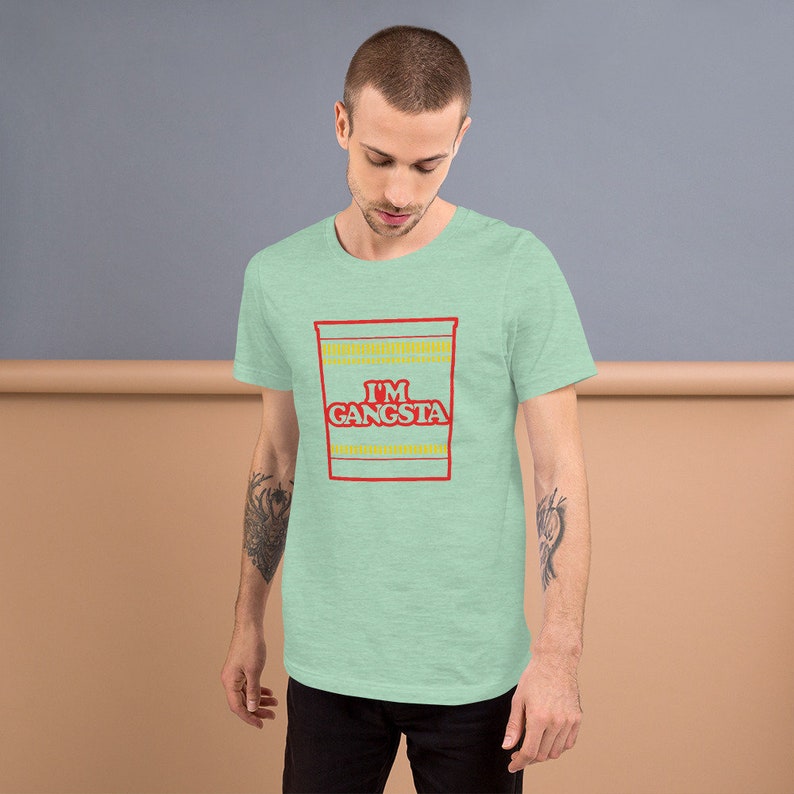 May include: A light green t-shirt with a graphic of a ramen noodle cup that says "I'm Gangsta" in red and yellow letters.