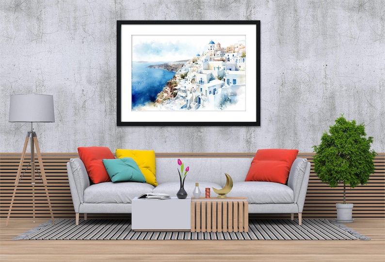 a modern living room with a gray sofa, a coffee table, and a framed painting of a coastal town. The painting is hung on a gray wall above the sofa, which has a wooden frame. The room also includes a potted plant, a lamp, and a vase on the coffee table.