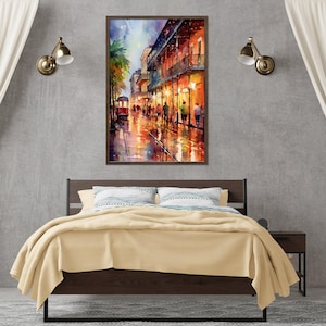 a bedroom with a large bed, a nightstand, and a framed painting of a city street scene hanging on the wall above the bed.