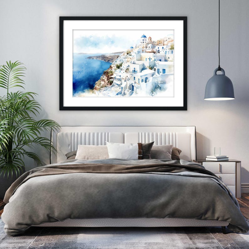a bedroom with a large bed, a framed painting of a coastal town, and a potted plant.