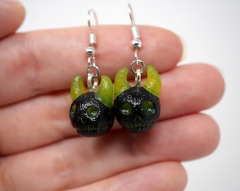 Pendientes de calavera de demonio verde neón y negro