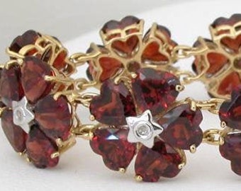 70 ctw Garnet Flower Station Bracelet with Heart Shaped Stones in 14k yellow gold. 7 or 7 1/4 inches long.