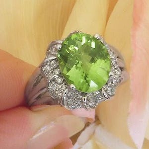 Unique Peridot Ring in 14k white gold with Fancy Diamond Halo Design
