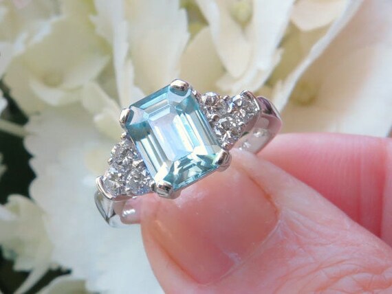 Emerald cut blue zircon ring deals