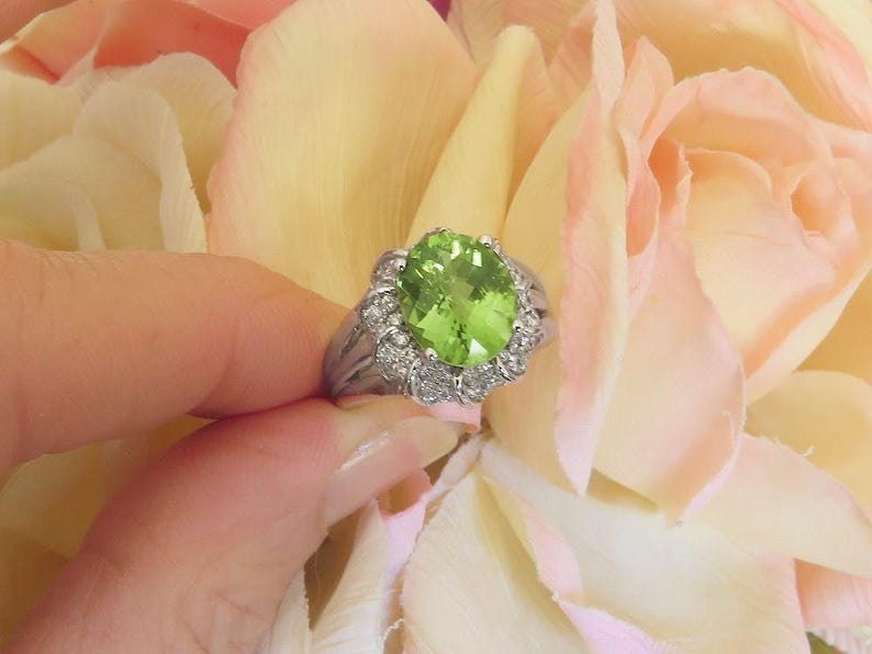 Unique Peridot Ring in 14k white gold with Fancy Diamond Halo Design
