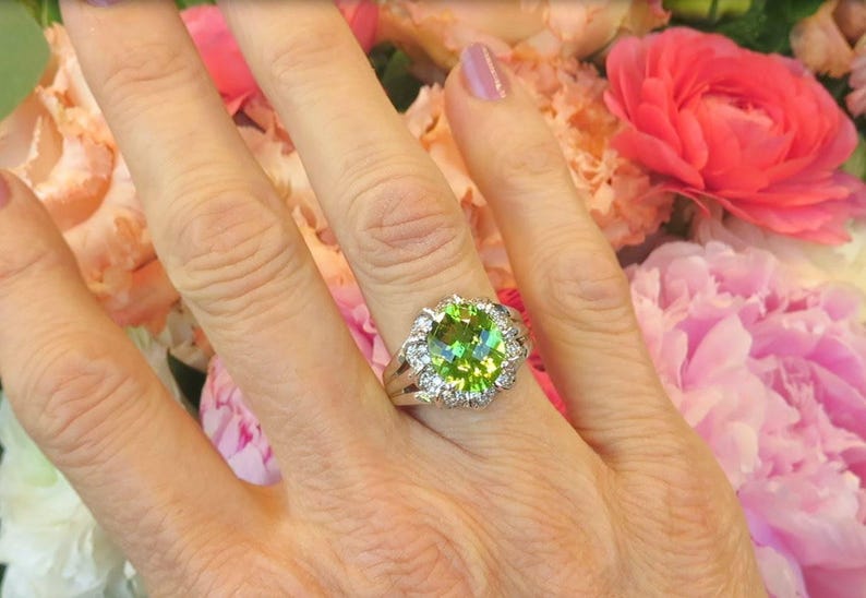 Juicy Green Peridot nearly 4 Carats in Size with 0.62 carats of Diamonds in 14k white gold