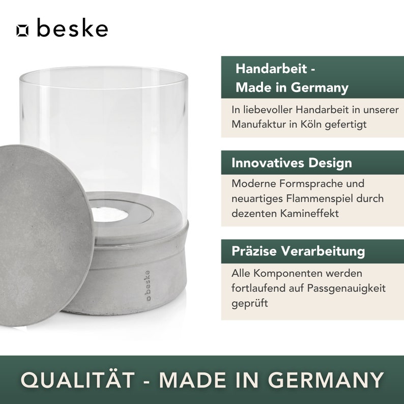 May include: A gray concrete candle holder with a glass cylinder. The candle holder has the text "beske" on the side. The text "Handarbeit - Made in Germany" is on a green background. The text "QUALIT&Auml;T - MADE IN GERMANY" is on a green background.