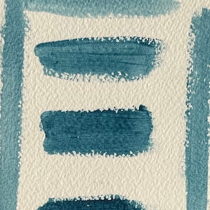 May include: Four horizontal brushstrokes of blue paint on a textured white background.