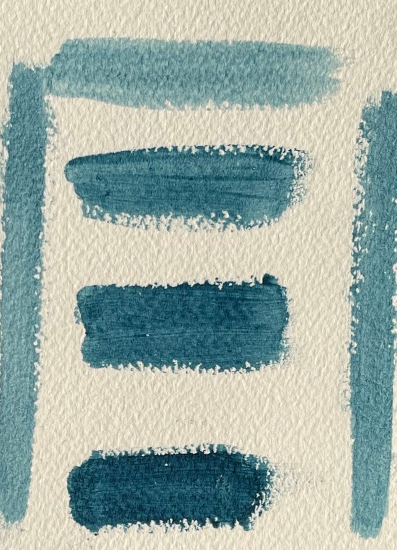 May include: Four horizontal brushstrokes of blue paint on a textured white background.
