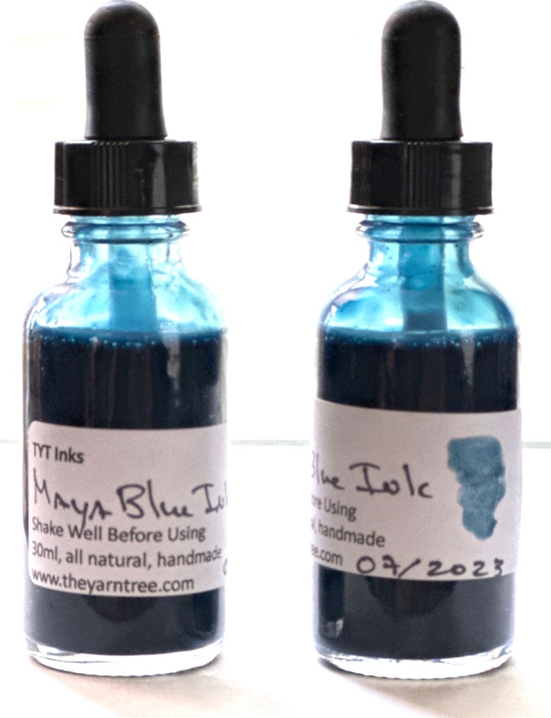 May include: Two small glass bottles with dropper tops filled with dark blue ink. The labels read "Maya Blue Ink" and "Blue Ink". The bottles are 30 ml and handmade.