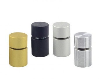 May include: Four different colored metal sign holders. The holders are cylindrical and have a small groove around the middle. The colors are gold, black, silver, and brushed silver.