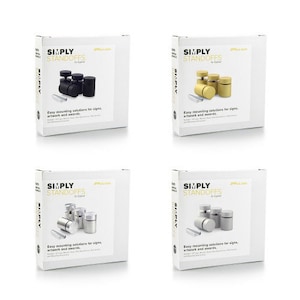 May include: Four white boxes with the text "SIMPLY STANDOFFS" and product images. Each box displays a different set of standoffs in black, gold, silver, and gray. The boxes also include the text "Easy mounting solutions for signs, artwork and awards."