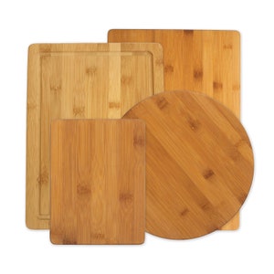 May include: Four wooden cutting boards, one square, one rectangular, one round, and one with a groove around the edge. All are made of light brown bamboo.