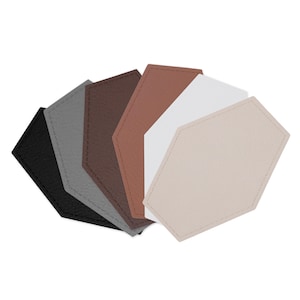 May include: A collection of six leather coasters in various colors: black, gray, brown, tan, white, and beige. Each coaster has a unique geometric shape with stitched edges. These coasters are designed to protect surfaces from drink condensation.